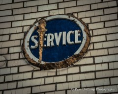 The torch has been chiseled away; and it appears the "Service" emblem has been tampered with as well
